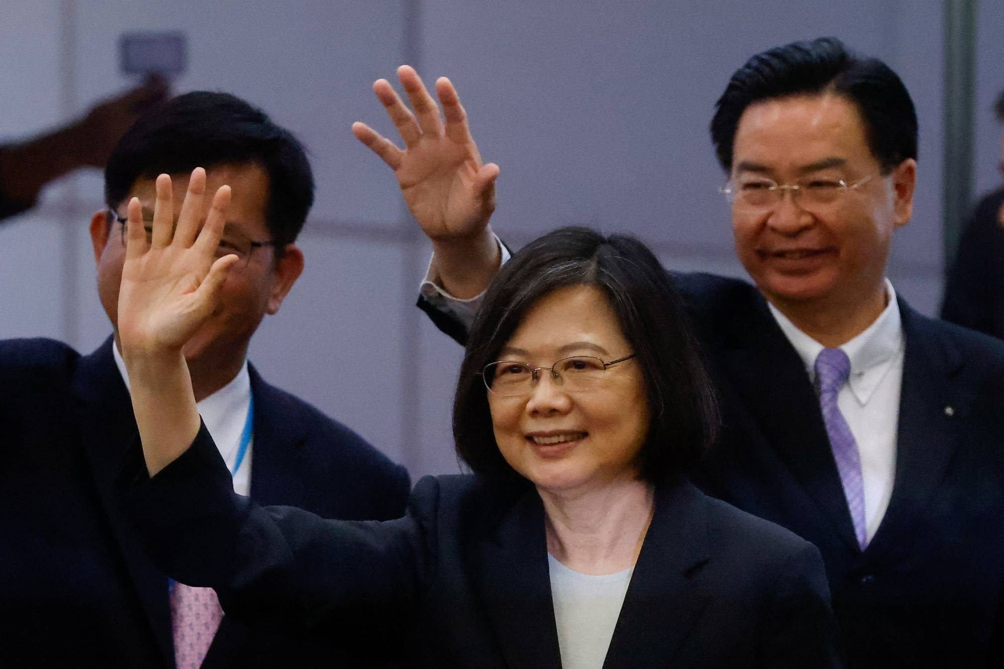 Taiwanese President Tsai Ing-wen waves to the media before her departure to New York to start her trip to Guatemala and Belize at Taoyuan International Airport in Taoyuan, Taiwan, on Wednesday. | REUTERS