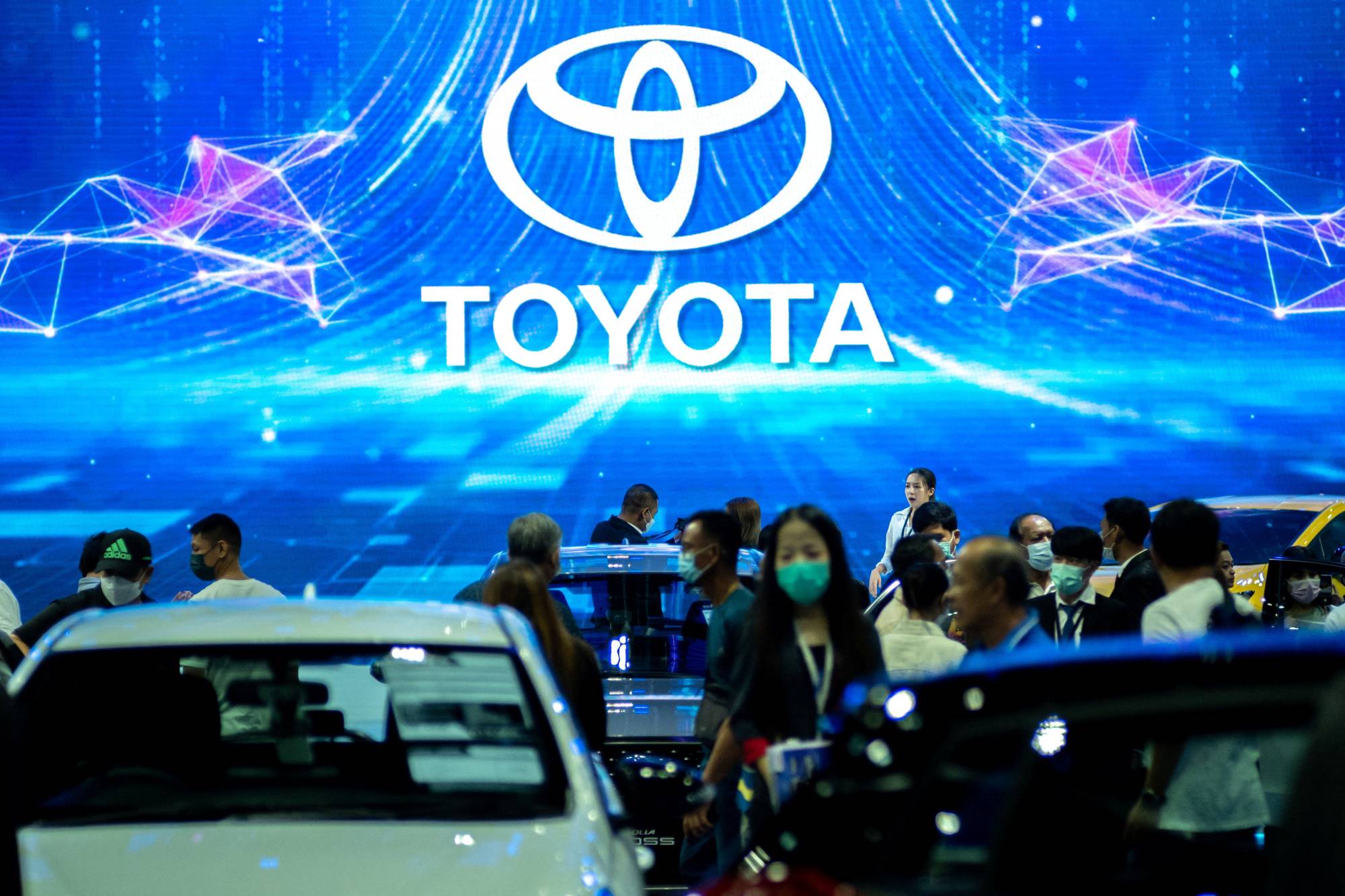 Toyota cars are displayed at an international motor show in Bangkok in March. Toyota's global sales in February hit a record high. | REUTERS