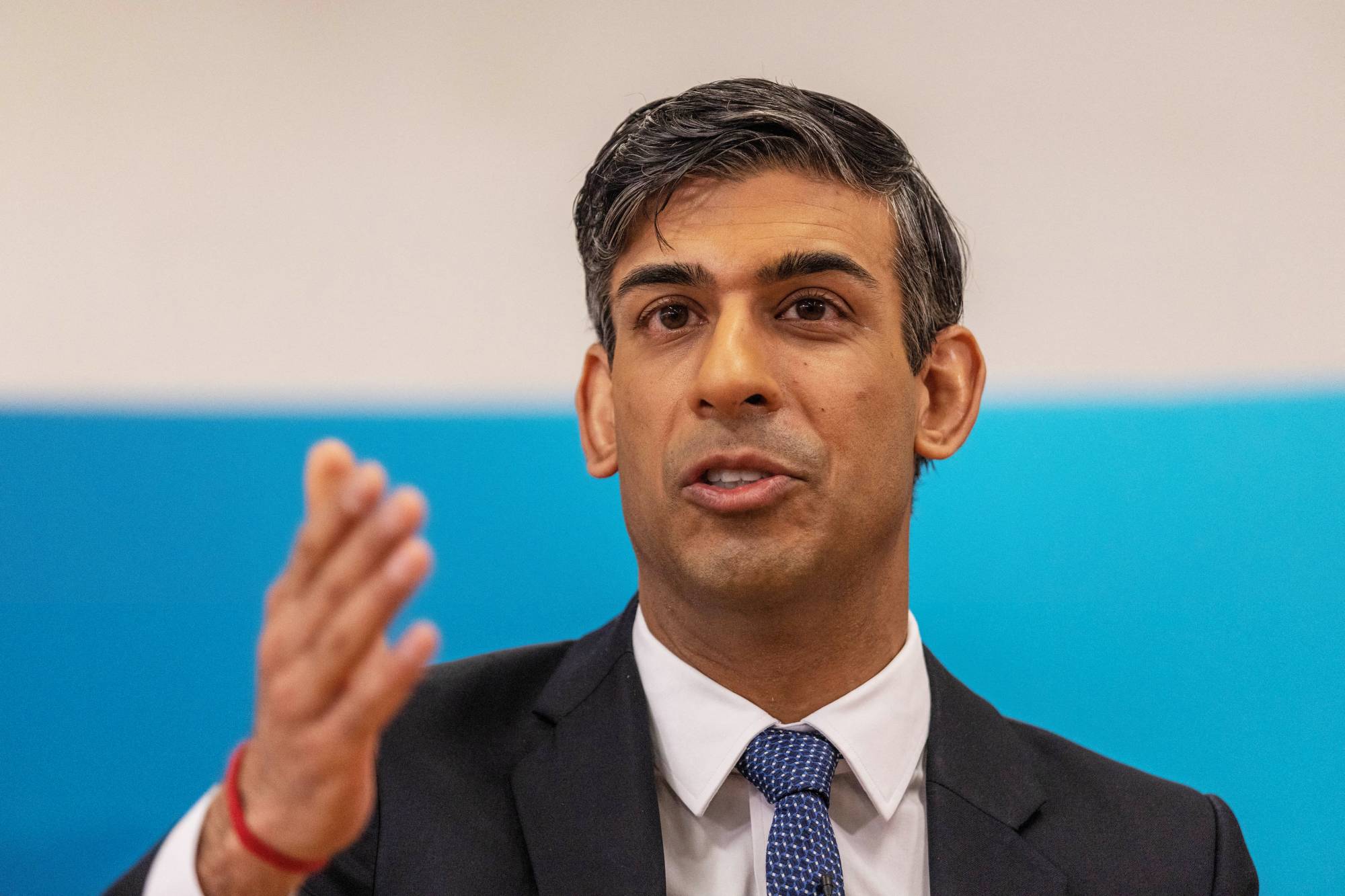 British Prime Minister Rishi Sunak speaks during an event on March 27. | POOL / VIA REUTERS