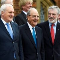 Irish Prime Minister Bertie Ahern (left), former U.S. Sen. George Mitchell (center) and former Sinn Fein leader Gerry Adams (right) stand with others for a group photograph at an event to celebrate the 20th anniversary of the Good Friday Agreement, in Belfast, Northern Ireland, on April 10, 2018. | REUTERS