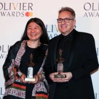 Kimie Nakano (left), winner of Best Costume Design for \"My Neighbor Totoro,\" and Tom Pye, winner of Best Set Design for the play, pose in the winner\'s room during the Olivier Awards 2023 at the Royal Albert Hall in London on Sunday. | REUTERS