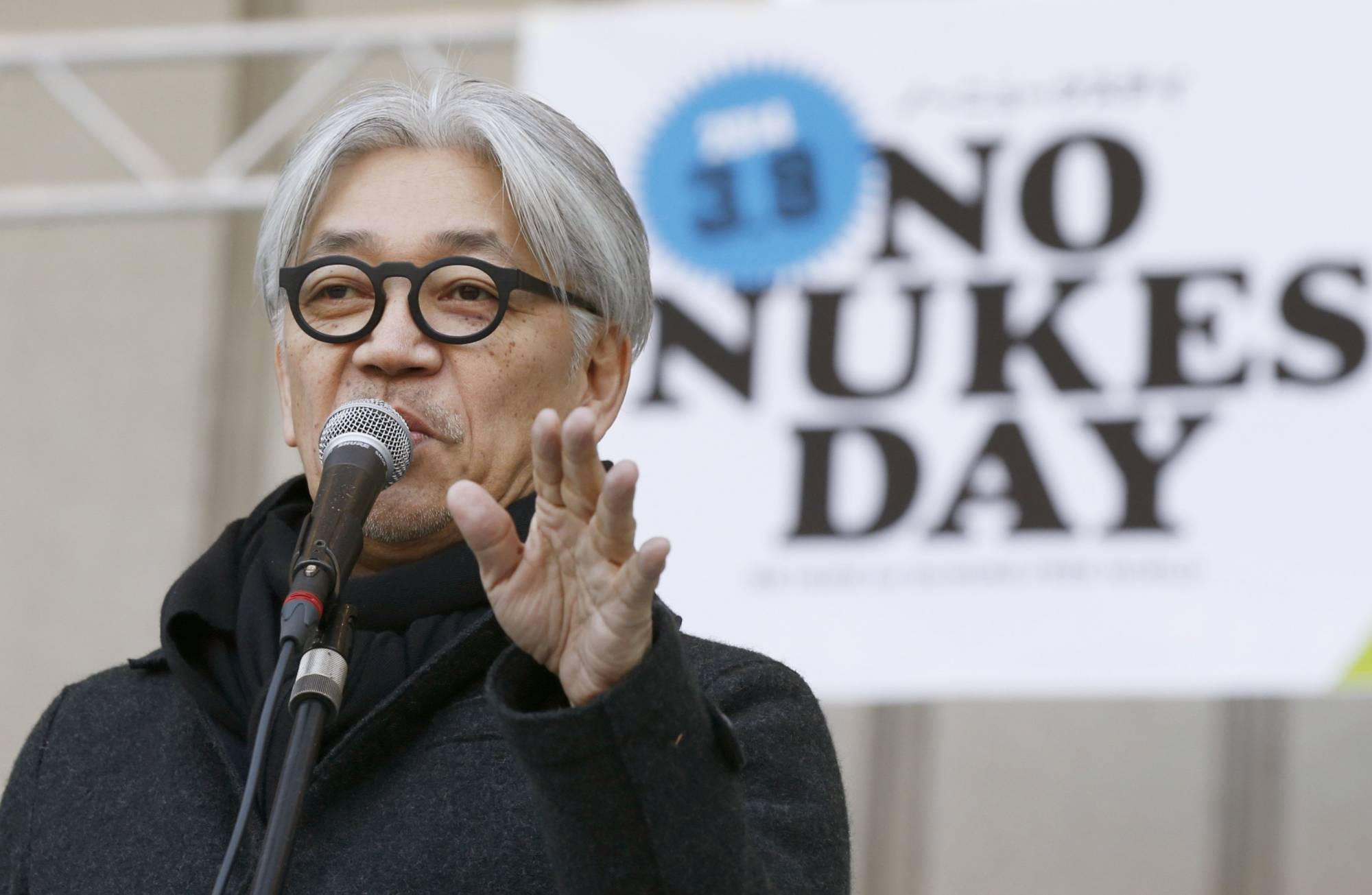 Ryuichi Sakamoto speaks at an anti-nuclear rally in Tokyo's Hibiya Park in March 2013. | KYODO