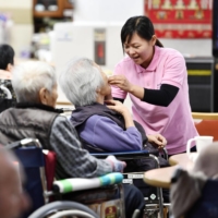 An Indonesian caregiver works at a nursing care facility in Nara Prefecture. | KYODO