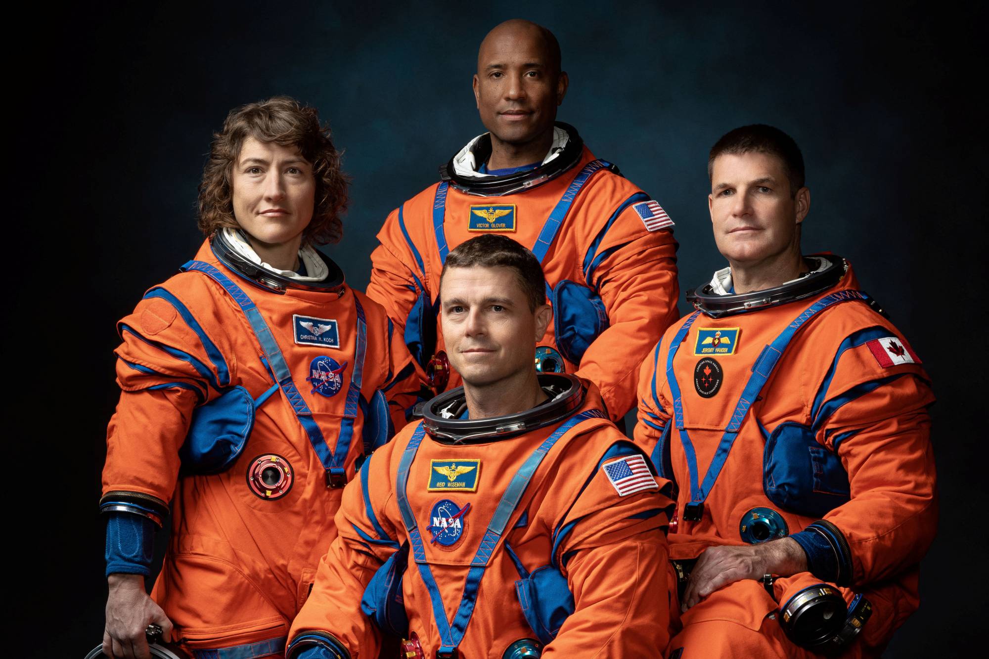 NASA astronauts Christina Koch, Victor Glover and Reid Wiseman and Canadian Space Agency astronaut Jeremy Hansen, the four-member team chosen for the Artemis II lunar flyby, pose wearing flight suits in Houston on Thursday. | NASA JOHNSON SPACE CENTER / VIA REUTERS 