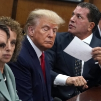 Former U.S. President Donald Trump appears in court with his legal team for an arraignment in New York on Tuesday.  | POOL / VIA REUTERS 