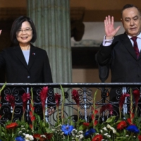 Taiwanese President Tsai Ing-wen (left) and Guatemala\'s President Alejandro Giammattei wave from a balcony at the Culture Palace in Guatemala City on March 31. | AFP-JIJI