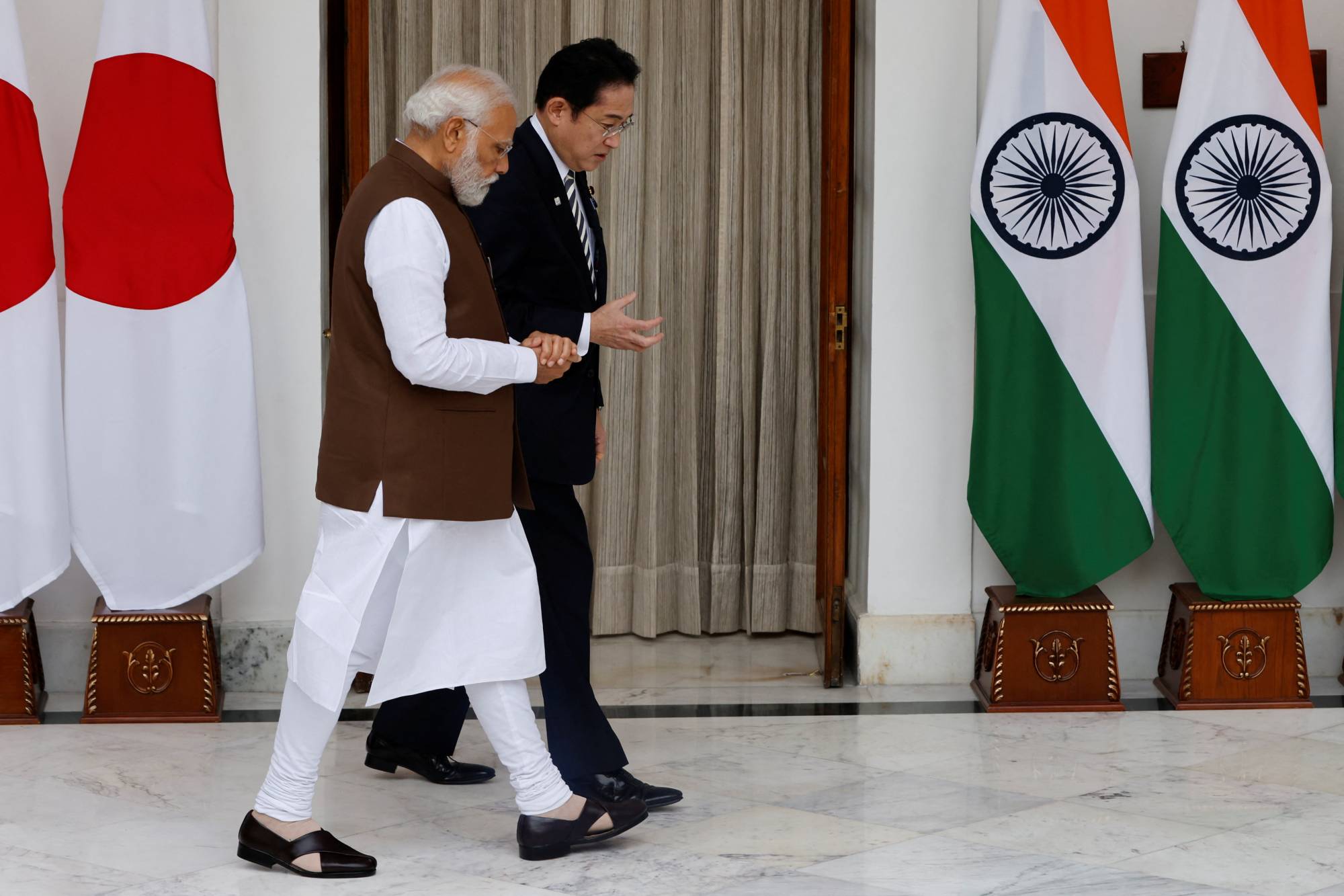 Indian Prime Minister Narendra Modi and Prime Minister Fumio Kishida talk before a meeting in New Delhi on March 20.  | REUTERS