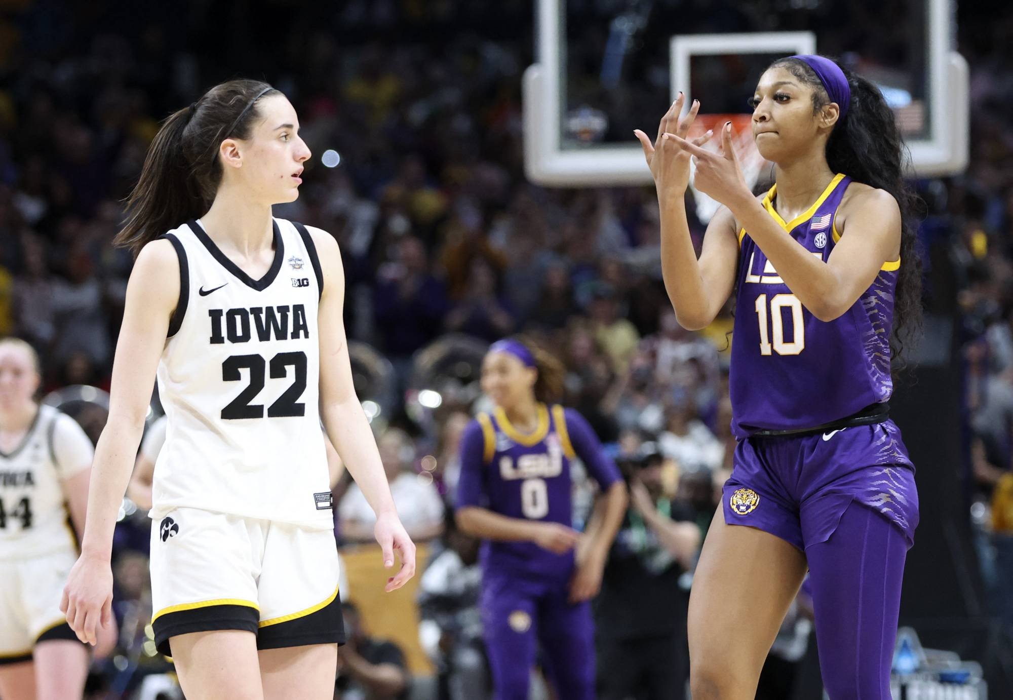 LSU forward Angel Reese (right) gestures to Iowa guard Caitlin Clark after the national championship game in Dallas on April 2. | USA TODAY / VIA REUTERS