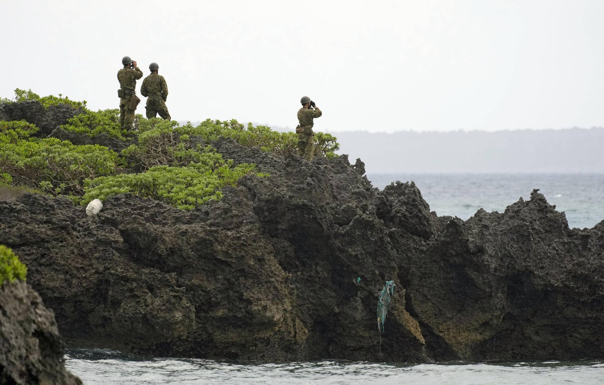 Self-Defense Force personnel scan waters around Miyakojima Island, Okinawa Prefecture, on Friday, near the site where a Ground Self-Defense Force helicopter went missing the previous day. | KYODO 