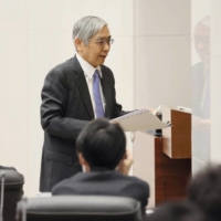 Haruhiko Kuroda leaves his last news conference as the central bank chief at the BOJ headquarters in Tokyo on Friday. | POOL / VIA REUTERS
