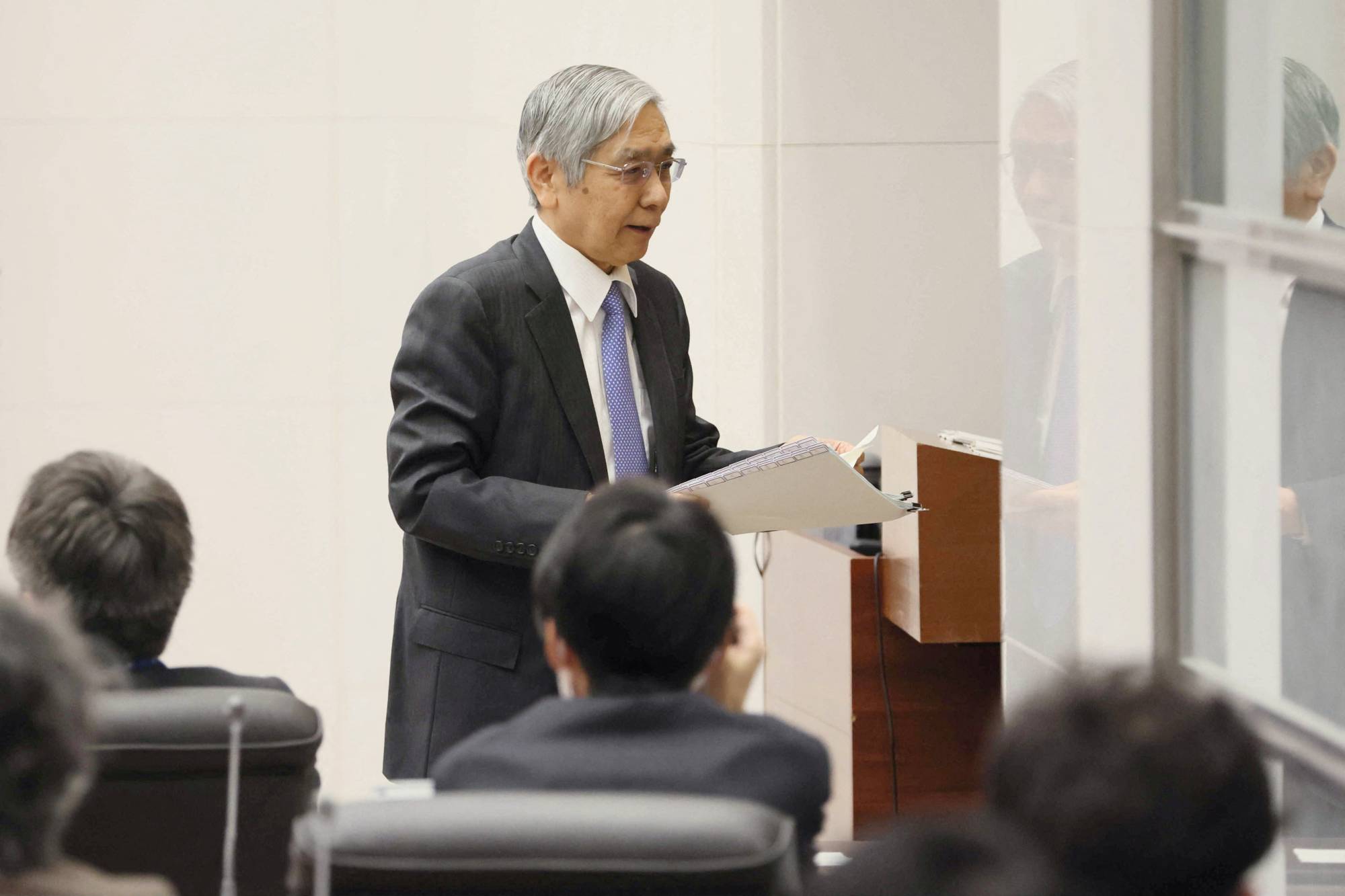 Haruhiko Kuroda leaves his last news conference as the central bank chief at the BOJ headquarters in Tokyo on Friday. | Pool / via REUTERS 
