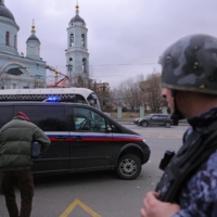 Wall Street Journal reporter Evan Gershkovich, detained on suspicion of espionage, is whisked away from a court building in Moscow on March 30. | REUTERS