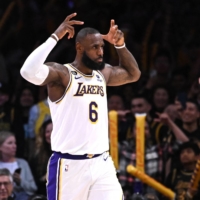Lakers forward LeBron James celebrates after making a 3-pointer against the Jazz in Los Angeles on Sunday. | USA TODAY / VIA REUTERS