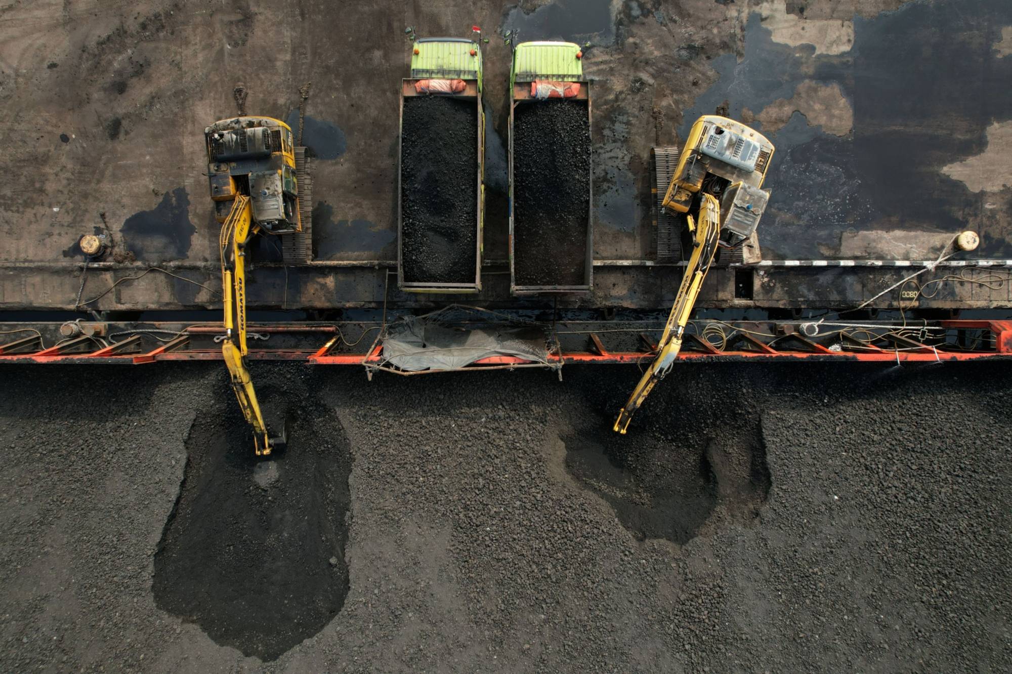 Coal on a barge loaded onto trucks at Cirebon Port in West Java, Indonesia, in May 2022 | BLOOMBERG