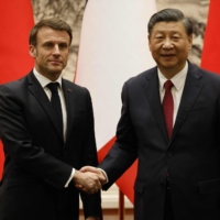 French President Emmanuel Macron and Chinese leader Xi Jinping hold a news conference at the Great Hall of the People in Beijing on Thursday.    | AFP-JIJI