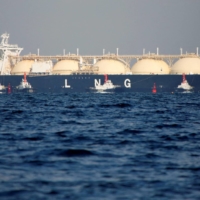 A liquefied natural gas tanker is tugged towards a thermal power station in Futtsu, Chiba Prefecture, in November 2017. | REUTERS