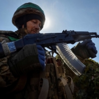 A Ukrainian service member at a position on a front line near the city of Bakhmut, Ukraine, on April 10 | REUTERS