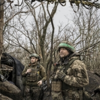 Ukrainian soldiers at a front line position in southern Bakhmut, Ukraine, watching the horizon where Russian troops are stationed, on April 7 | MAURICIO LIMA / THE NEW YORK TIMES