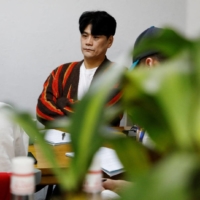Choi Jin-mook, 48, Chief Director of the Drug Addiction Rehabilitation Centre (DARC) and visiting professor at the Department of Addiction Rehabilitation and Social Welfare at Eulji University, listens to a recovering drug addict during a group counseling session in Incheon, South Korea. | REUTERS
