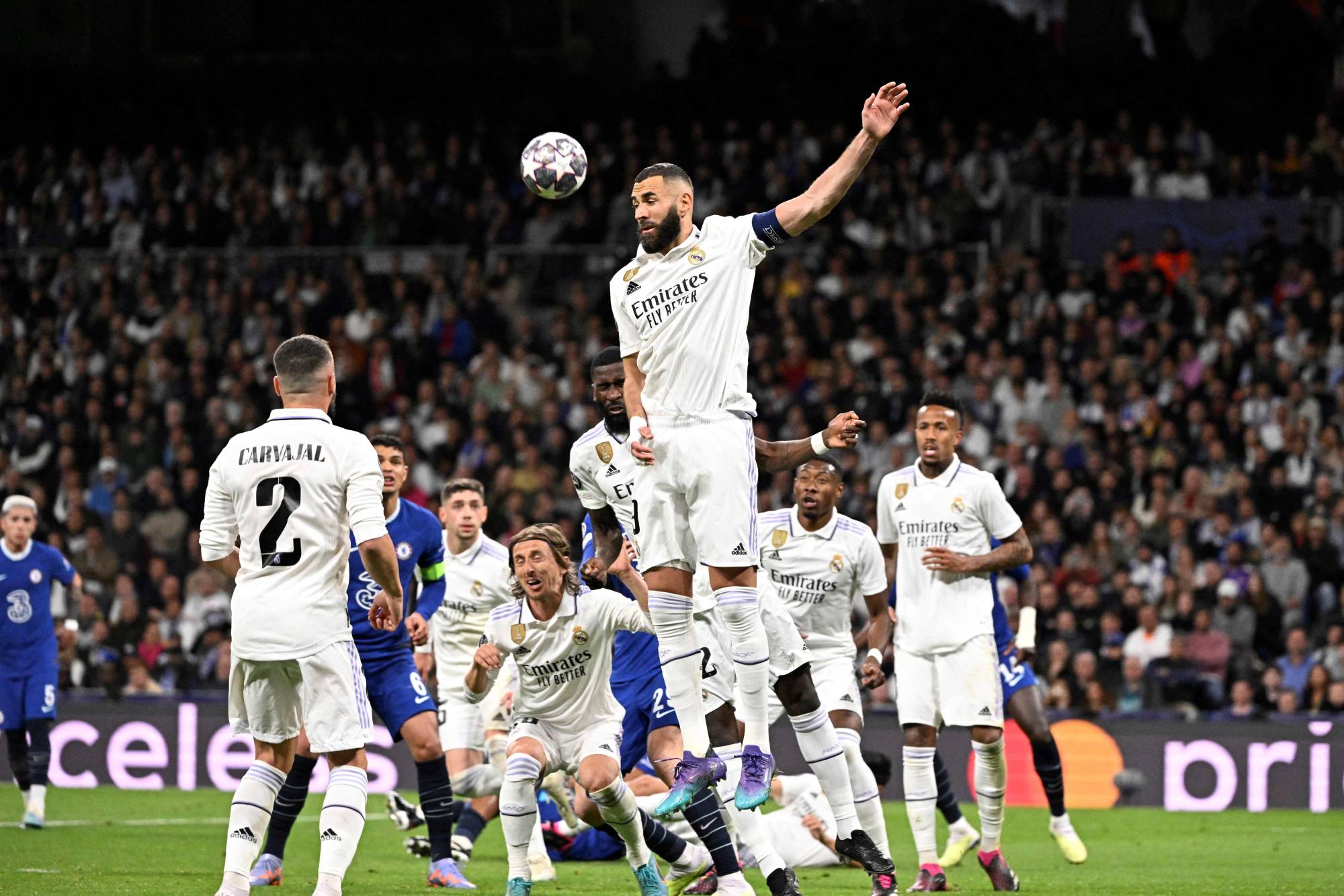 Real Madrid's Luka Modric, right, heads the ball past Manchester