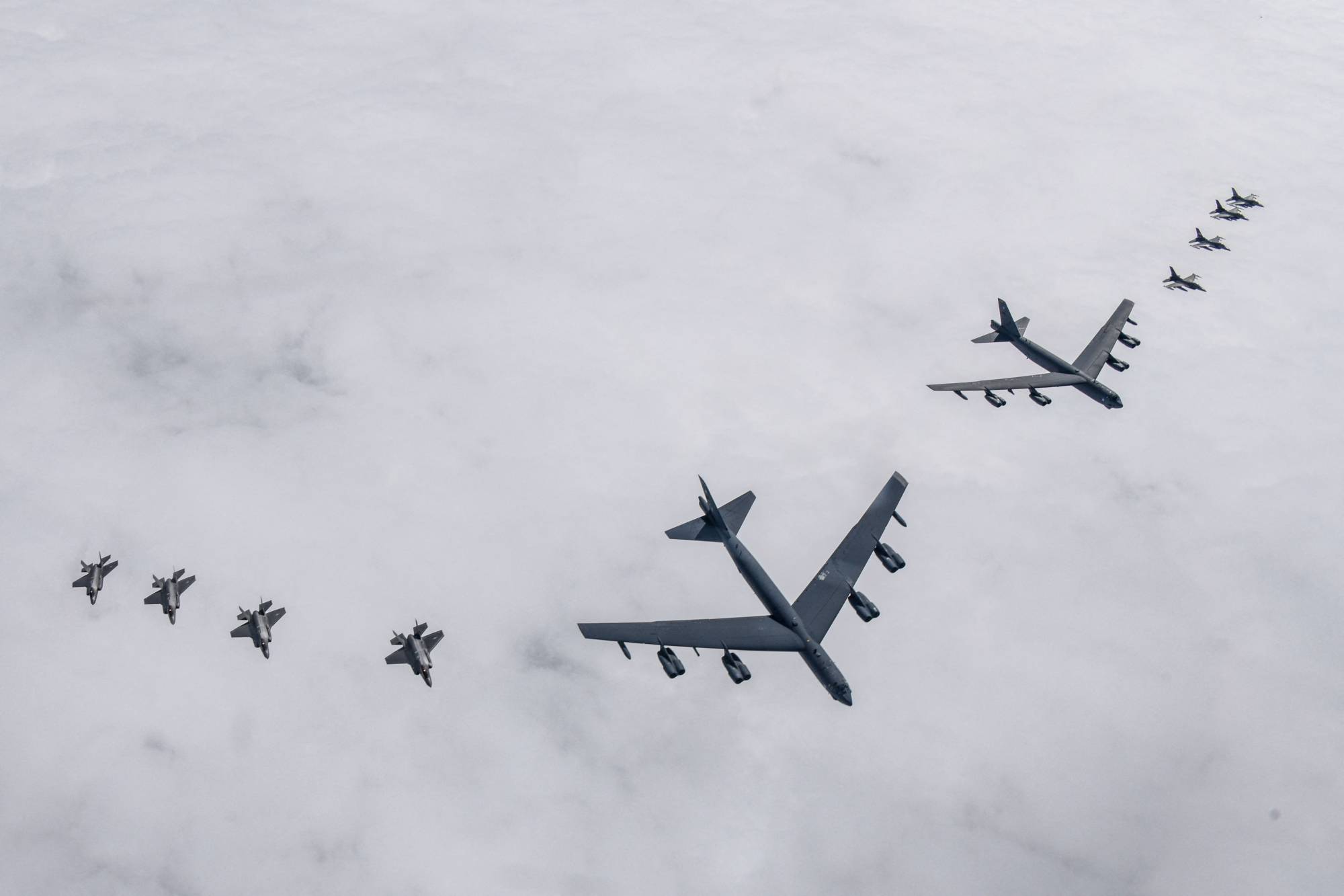 Two U.S. B-52H strategic bombers fly with South Korean Air Force F-35As and U.S. Air Force F-16 fighter jets during a joint air drill over South Korea on Friday. | SOUTH KOREAN DEFENSE MINISTRY / VIA AFP-JIJI