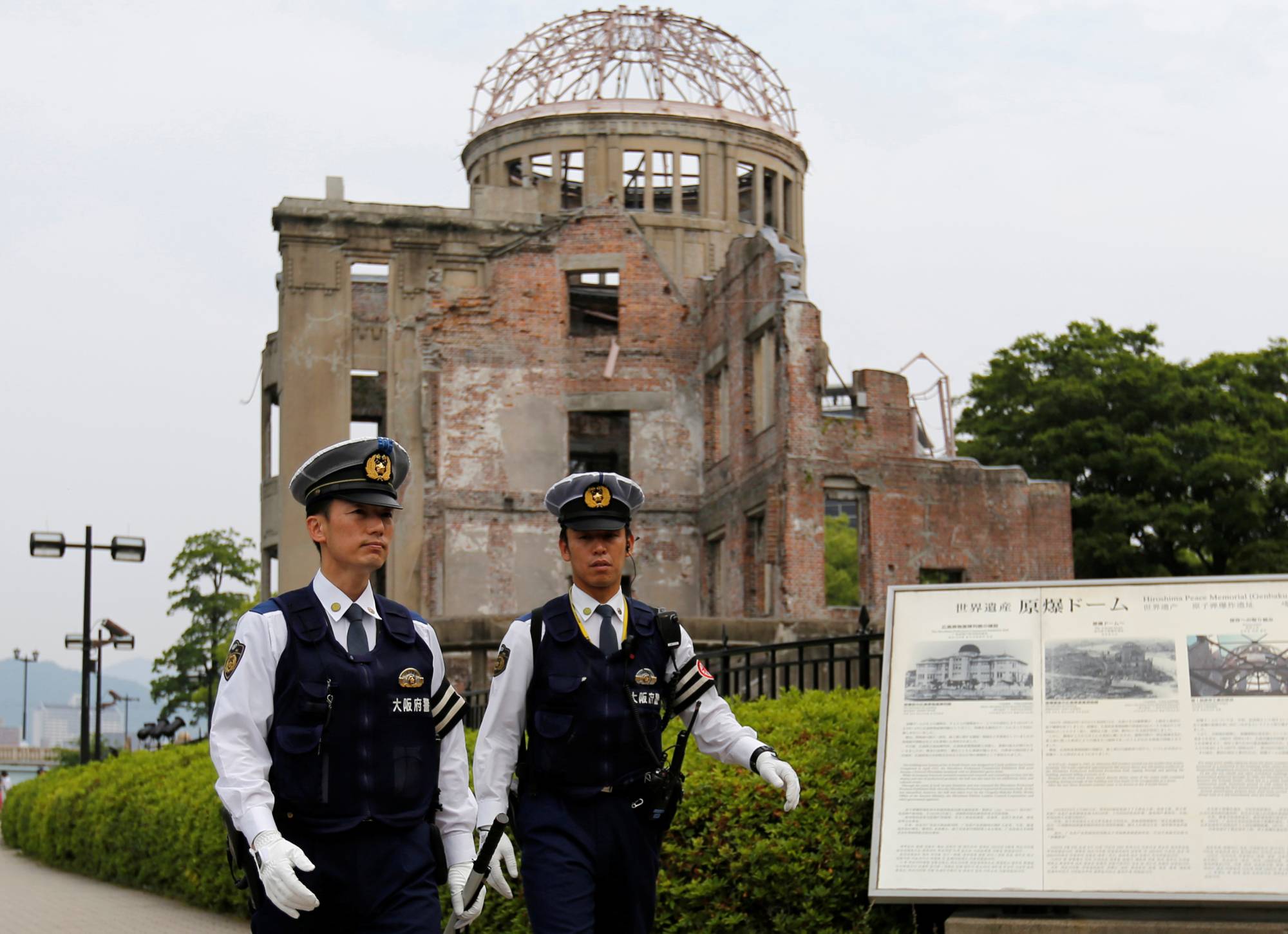 Police officers stand guard in front of the Atomic Bomb Dome at the Peace Memorial Park in Hiroshima. | REUTERS