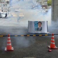Smoke billows after an explosion was heard near Kishida\'s speech in Wakayama Prefecture on Saturday. | TWITTER / @AK2364N / VIA REUTERS  