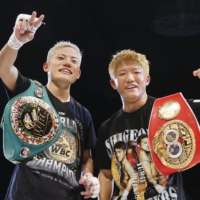 Yudai Shigeoka (left) and Ginjiro Shigeoka celebrate after winning their respective bouts on Sunday. | KYODO