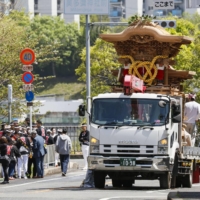 A Danjiri float is transported by truck after it fell over in Sakai, Osaka Prefecture, on Sunday. | KYODO