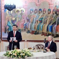 Russian President Vladimir Putin and Chinese President Xi Jinping attend a reception at the Kremlin in Moscow on March 21 | KREMLIN / SPUTNIK / VIA REUTERS 
