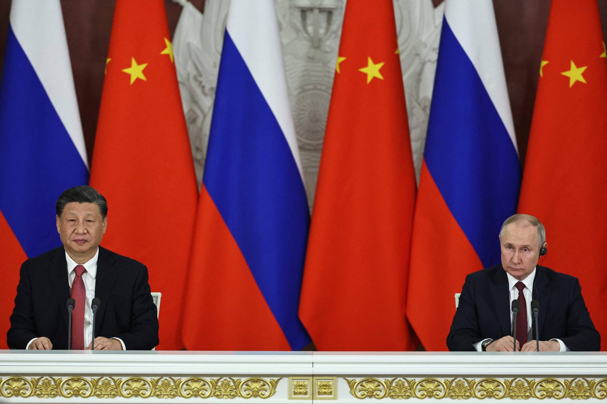 Russian President Vladimir Putin and China's President Xi Jinping deliver a joint statement following their talks at the Kremlin in Moscow on March 21 | SPUTNIK / via AFP-Jiji