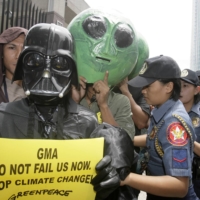 Protesters demonstrate outside the Asian Development Bank headquarters in Manila during climate change talks in June 2009.   | REUTERS