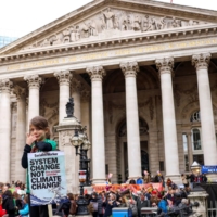 Climate change protesters demonstrate outside the Bank of England in London during the U.N. Climate Change Conference in November 2021. 
 | REUTERS