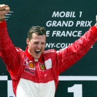 Michael Schumacher, seen on the podium after winning the French Grand Prix in 2002, has not been seen in public since suffering a serious brain injury in 2013. | REUTERS