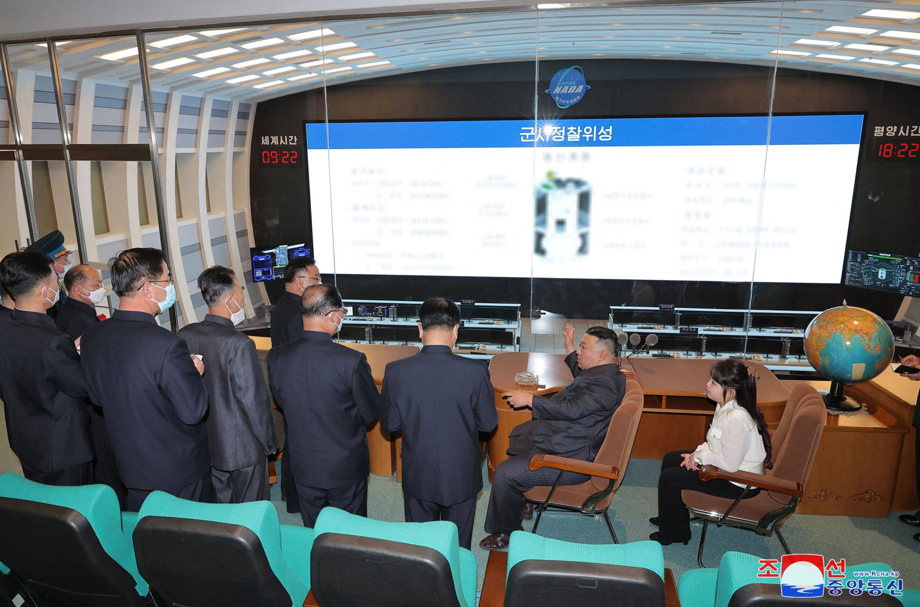 North Korean leader Kim Jong Un and his daughter visit the country's National Aerospace Development Administration in this photo released Wednesday. | KCNA / KNS / VIA AFP-JIJI