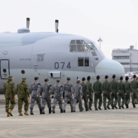 Self-Defense Forces personnel board a C-130 transport aircraft at the Air Self-Defense Force\'s Komaki Air Base in Aichi Prefecture on Friday. | KYODO
