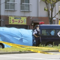 Police outside a ramen shop in Kobe where a man, believed to be the owner, was found dead on Saturday.  | KYODO 