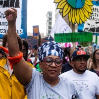 Environmental activists protest the use of fossil fuels on Earth Day as they march to the White House in Washington on Saturday.  | AFP-JIJI