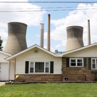 A coal-fired power plant behind a home in Poca, West Virginia, in 2014 | REUTERS