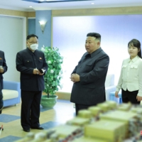 North Korean leader Kim Jong Un and his daughter visit the country\'s National Aerospace Development Administration at an undisclosed location in this photo released Wednesday. | KCNA / KNS / VIA AFP-JIJI