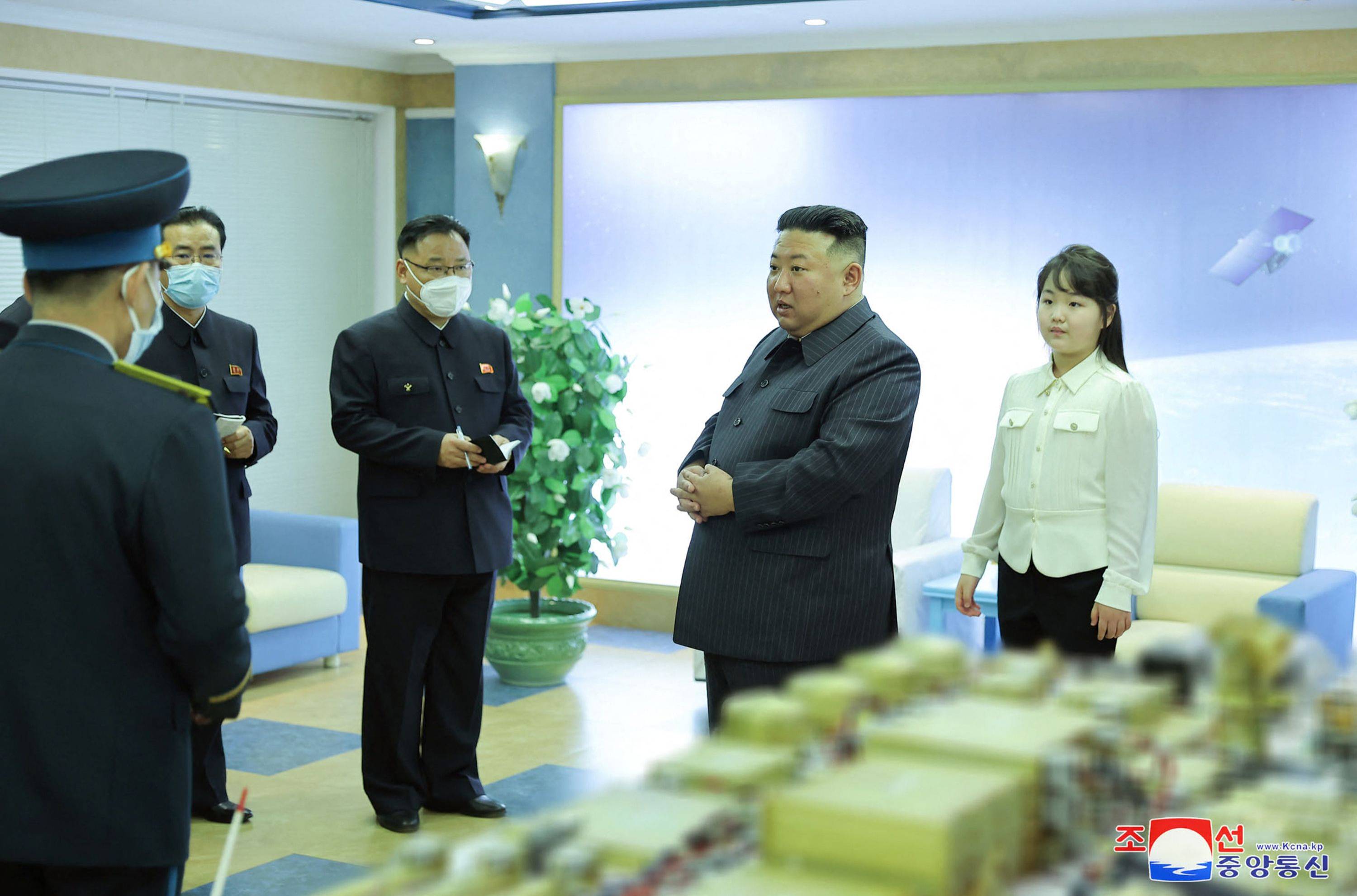 North Korean leader Kim Jong Un and his daughter visit the country's National Aerospace Development Administration at an undisclosed location in this photo released Wednesday. | KCNA / KNS / VIA AFP-JIJI