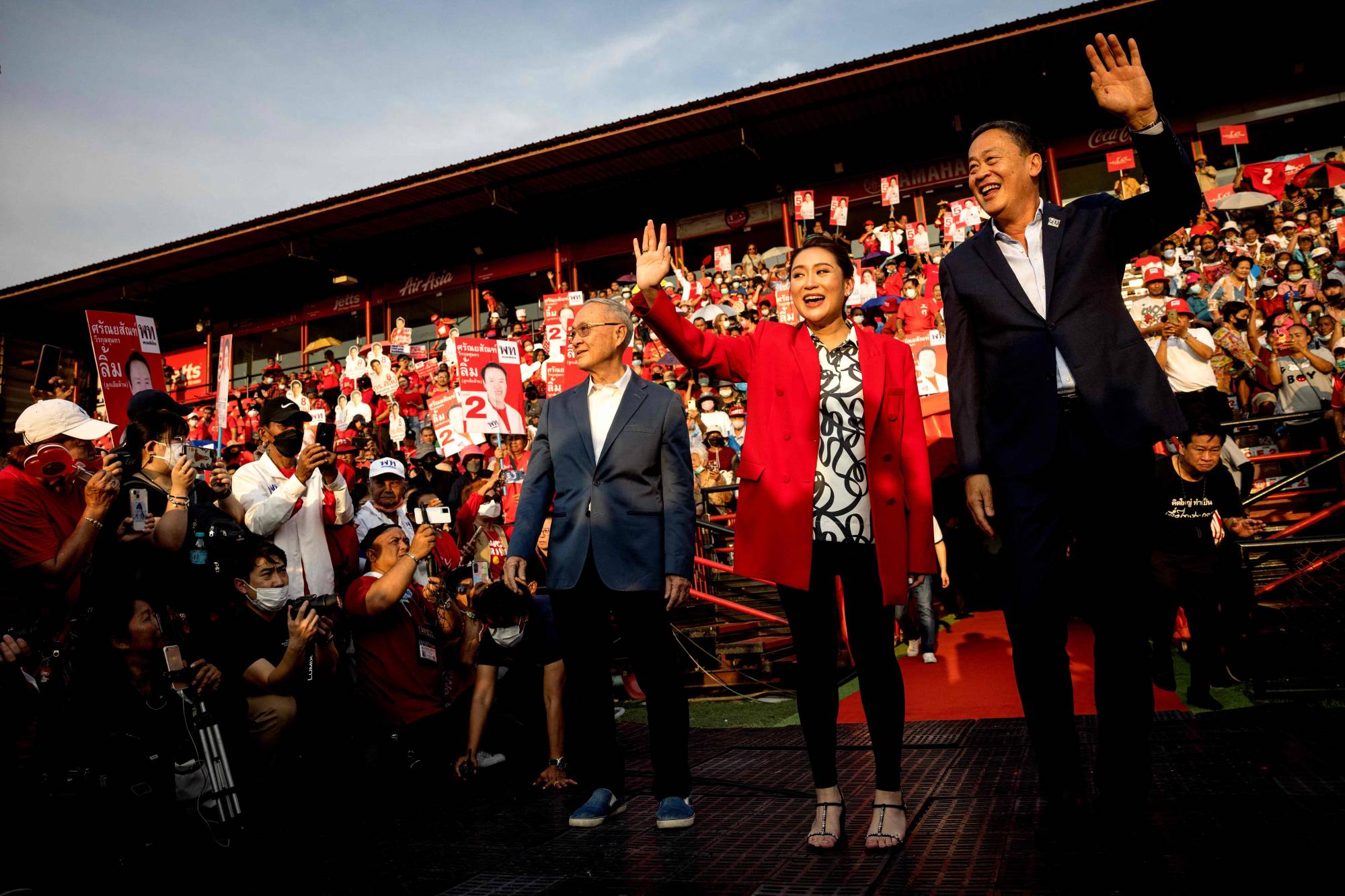 Thai candidates for prime minister Paetongtarn Shinawatra (center), Srettha Thavisin (right) and Chaikasem Nitisiri (left) attend an election rally for Thailand's main opposition Pheu Thai party at the Thunder Dome Stadium in Nonthaburi, north of the capital Bangkok | AFP-JIJI