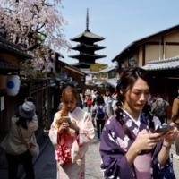 Tourists near Kiyomizu Temple in Kyoto on March 30. In October, the government eased its travel restrictions, allowing visa-free, independent tourism with no daily cap | REUTERS