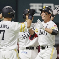 The Hawks\' Ryoya Kurihara (right) celebrates with his teammates after hitting a grand slam against the Eagles in Fukuoka on Thursday. | KYODO