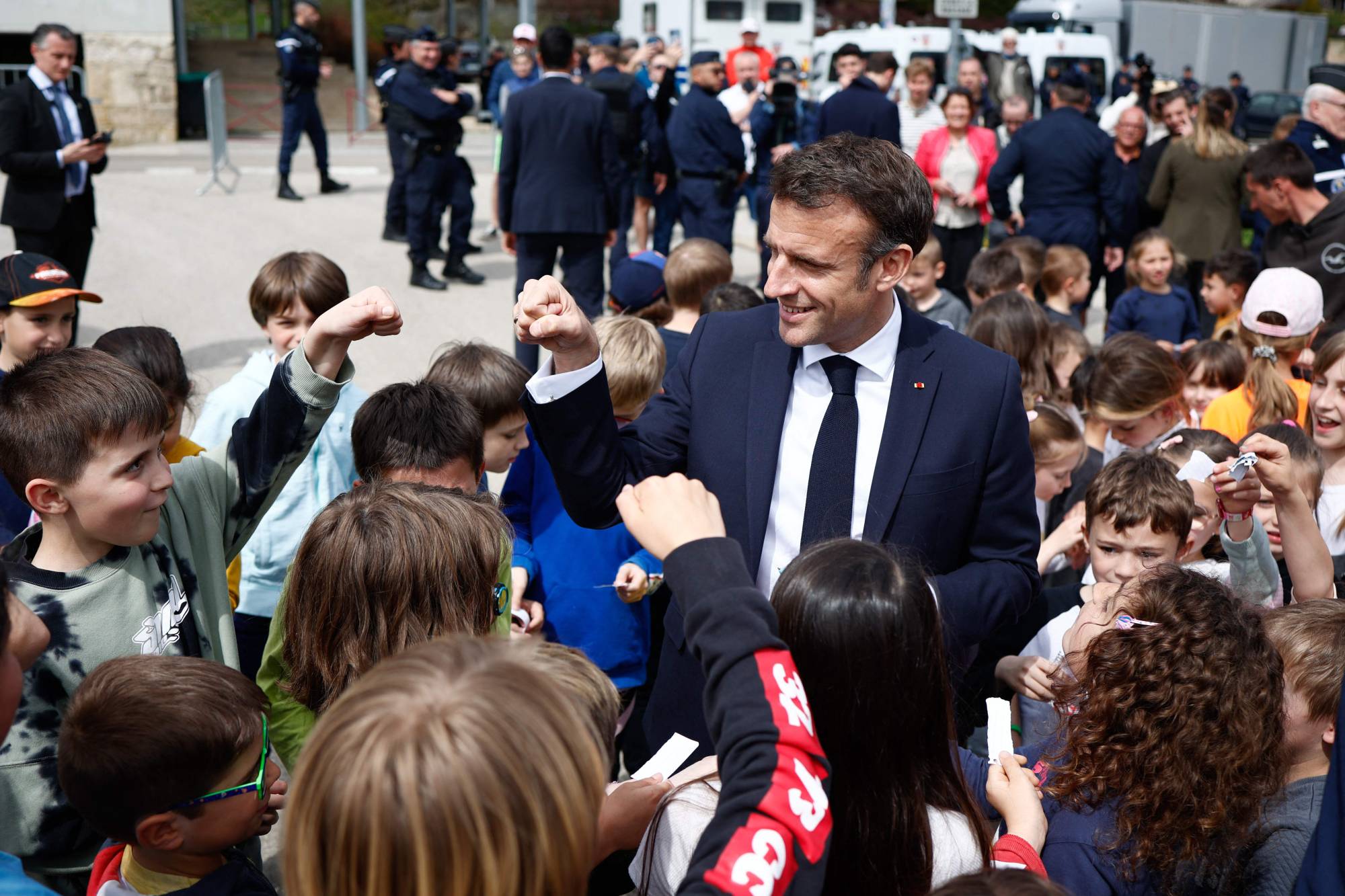 French President Emmanuel Macron meets children at a school in La Cluze-et-Mijoux on Thursday.  | POOL / VIA AFP-JIJI