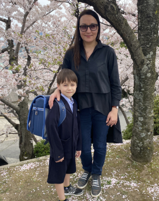 A young Ukrainian war refugee enjoys the cherry blossoms in Hiroshima after starting elementary school in April.