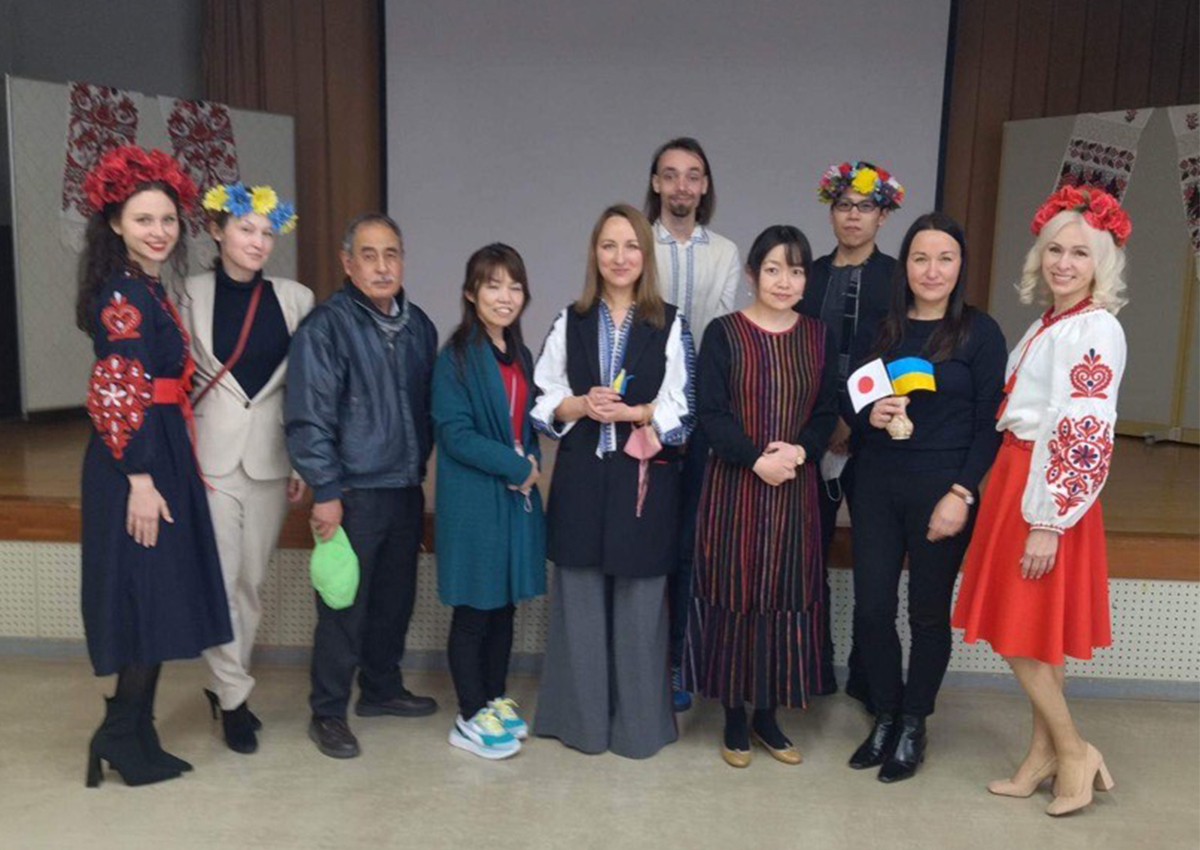Volunteers pose with Ukrainian refugees in Hiroshima after a charity event in February.
