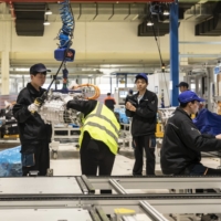 Workers on the production line of electric vehicle motors and drive control systems at a factory in Ningbo, China, on Feb. 22 | BLOOMBERG