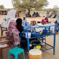 Fatma Dahab Ousman, a Sudanese refugee who fled the violence in her country, sells tea and porridge to other refugees near the border between Sudan and Chad, in Koufroun, Chad, on Monday. | REUTERS