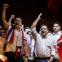 President-elect Santiago Pena (left) and Colorado Party leader Horacio Cartes celebrate in Asuncion, Paraguay, as they declare victory in the presidential election on Sunday. | MARIA MAGDALENA ARRELLAGA / THE NEW YORK TIMES